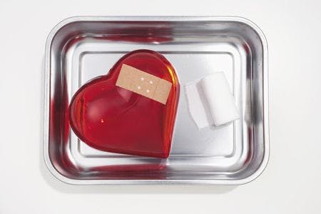 veterinary-still-life-of-red-heart-covered-with-band-aid-in-silver-bowl-78233733-450px.jpg