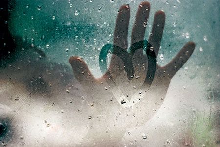 450veterinary-Hand-touching-a-broken-heart-on-a-rainy-window-99564528.jpg